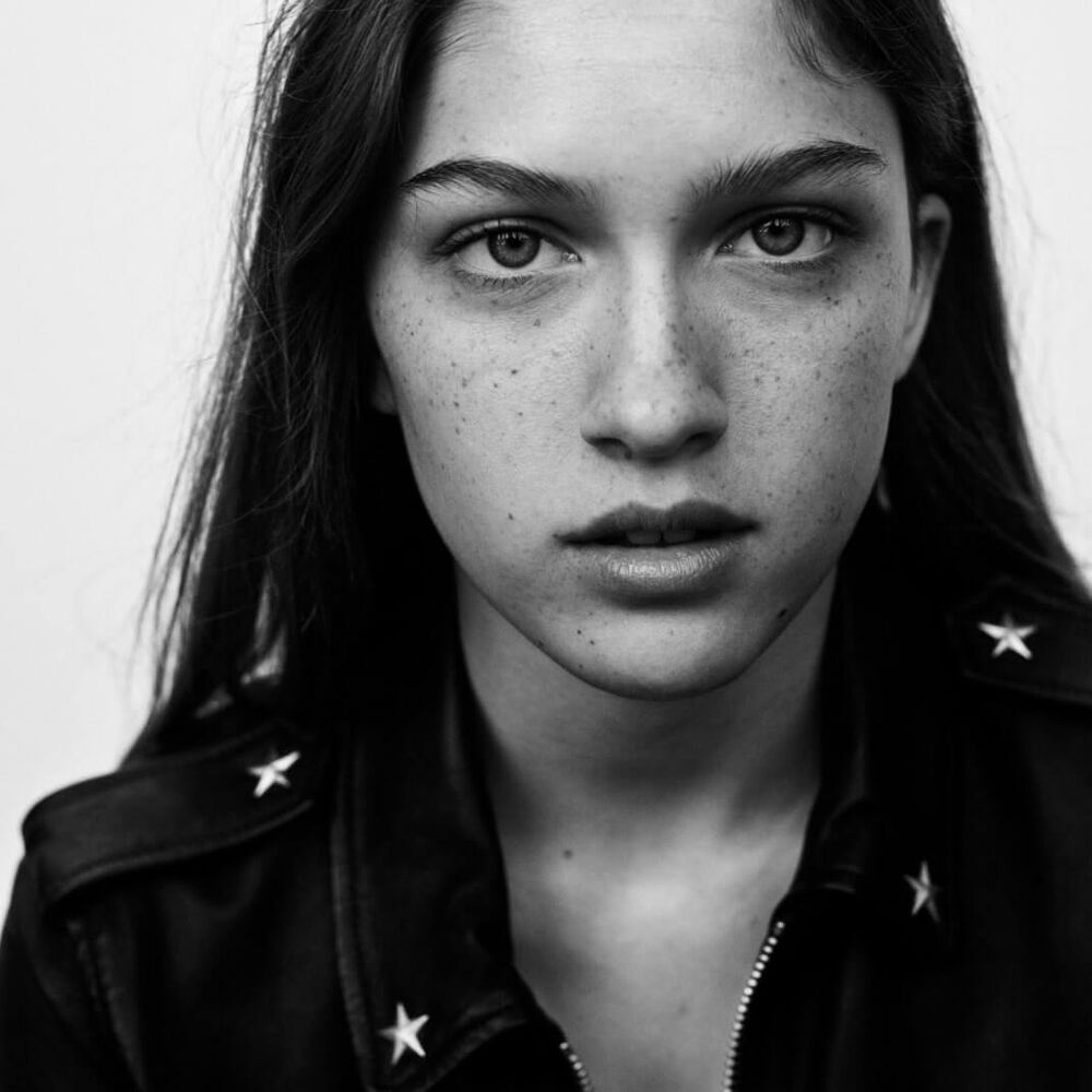Black and white portrait of a woman wearing a leather jacket